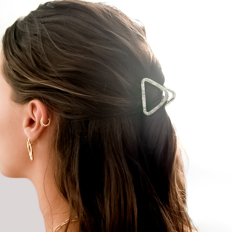 Woman wearing a small sage French style triangle hair claw clip in a half updo, for all hair types