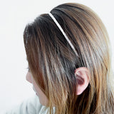 Sustainable and stylish, this boho-inspired headband features a super skinny, ultra-thin shape that blends comfort with structure. Wrapped in eco-friendly vintage fabric Hair band in Ivory - Maison Soyenne